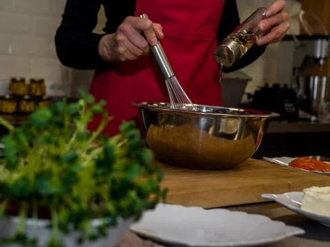 The process of making pancakes. Cook in the kitchen makes the dough Stock-Fotos