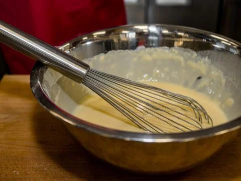 The process of making pancakes. Cook in the kitchen makes the dough Stock-Fotos