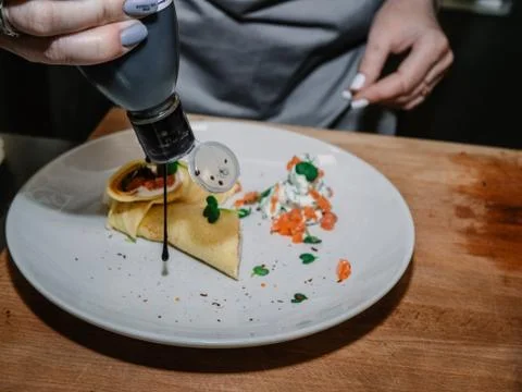 The process of making pancakes. Cook in the kitchen makes the dough. 스톡 사진