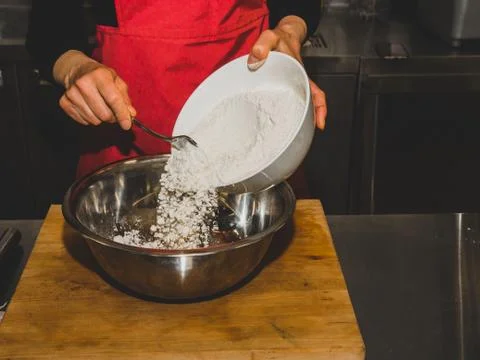The process of making pancakes. Cook in the kitchen makes the dough. Fotos Stock