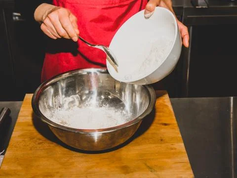The process of making pancakes. Cook in the kitchen makes the dough. 写真素材