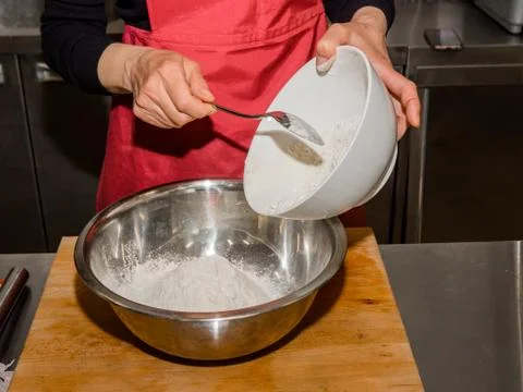 The process of making pancakes. Cook in the kitchen makes the dough. 스톡 사진