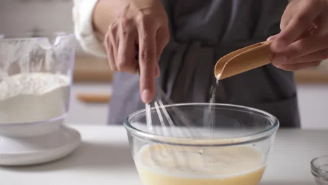 The process of making pancakes in the early morning mom cook prepares batter Stock Footage 205480903