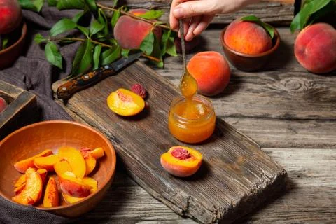 The process of making peach jam, cooking peach dessert on rustic cutting boar Stock Photos