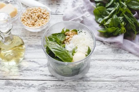 The process of making pesto sauce in a blender from cheese, pine nuts, olive  Stock Photos