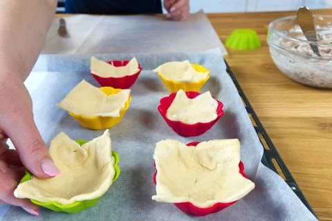 The process of making pies for snacks from dough in selcon forms Stock Photos