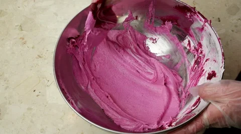 Process of making pink Macaron, mixing in the iron bowl Stock Footage 62425762