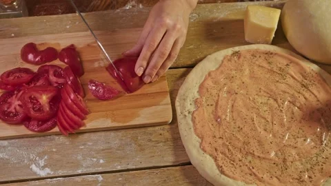 Process of making pizza Margarita. tomato is cut into pieces while piece of Stock Footage 301251869