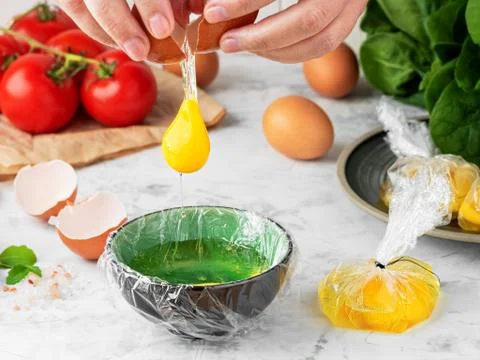 The process of making poached or benedict eggs. The cook pours an egg into a 스톡 사진