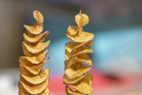 The process of making potato chips at home. Potato finely chopped into thin Stock Photos