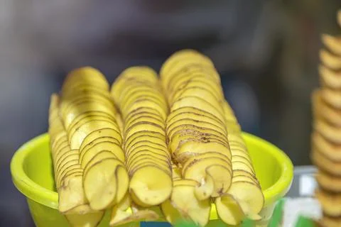The process of making potato chips at home. Potato finely chopped into thin Stock Photos