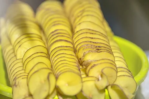 The process of making potato chips at home. Potato finely chopped into thin Stock Photos