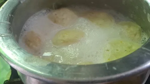 Process of making ras malai in a shiny silver pot Stock Footage 318664006