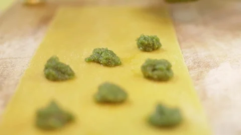 Process of making ravioli, put a filling on a thin layer of dough, close up Stock Footage 74532796