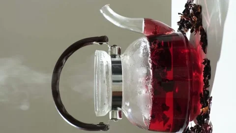 The process of making red hibiscus tea from sudanese rose flowers in a glass Stock Footage 232999029