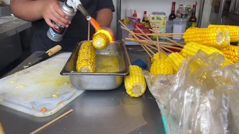 The process of making roasted corn that is very delicious and ready to eat Stock Footage 276259864