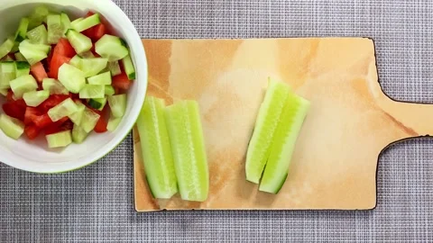 The process of making a salad of fresh cucumbers and tomatoes. Recipe. Stock Footage 151193631