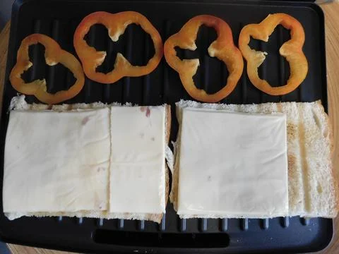 The process of making a sandwich with ham, cheese and egg 스톡 사진