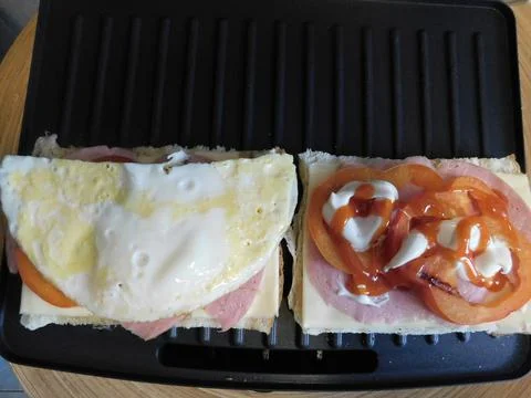 The process of making a sandwich with ham, cheese and egg Stock Photos