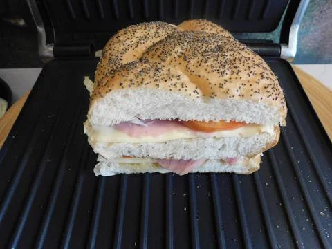 The process of making a sandwich with ham, cheese and egg 스톡 사진