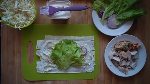 The process of making shawarma with female hands on a wooden table, top view. Stock Footage 104725034