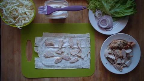 The process of making shawarma with female hands on a wooden table, top view. 스톡 동영상 104725293
