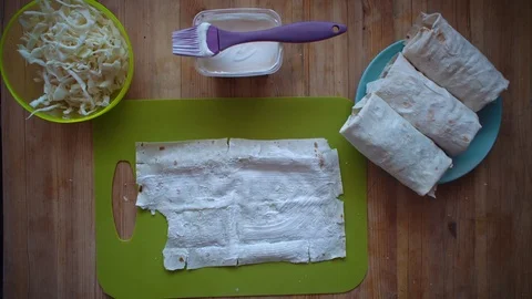 The process of making shawarma with female hands on a wooden table, top view. Stock Footage 104749228
