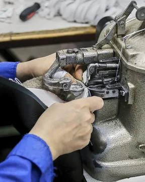 The process of making shoes in a factory. Stock Photos