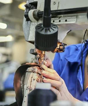 The process of making shoes in a factory. Stock Photos