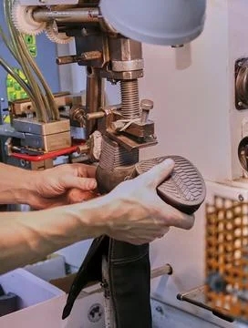 The process of making shoes in a factory. Stock Photos