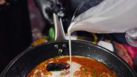 The process of making soup is a tom yam. The cook pours the cream into a frying Stock Footage 147717082