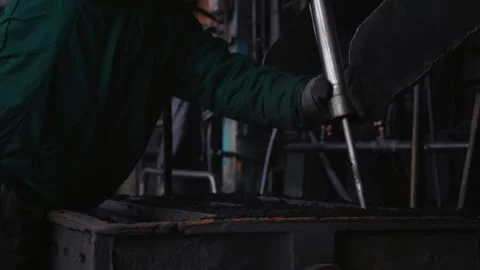 The process of making steel by which man introduces sand into molds and presses. Stock Footage 296546004
