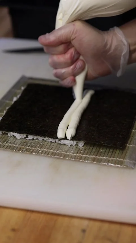 The process of making sushi rolls in a professional restaurant kitchen Видео 332490277