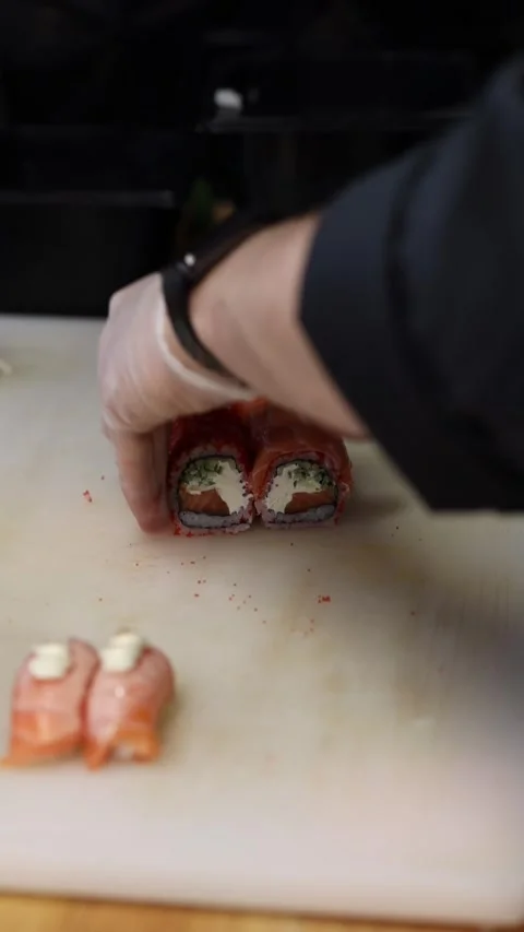 The process of making sushi rolls in a professional restaurant kitchen Видео 332490372