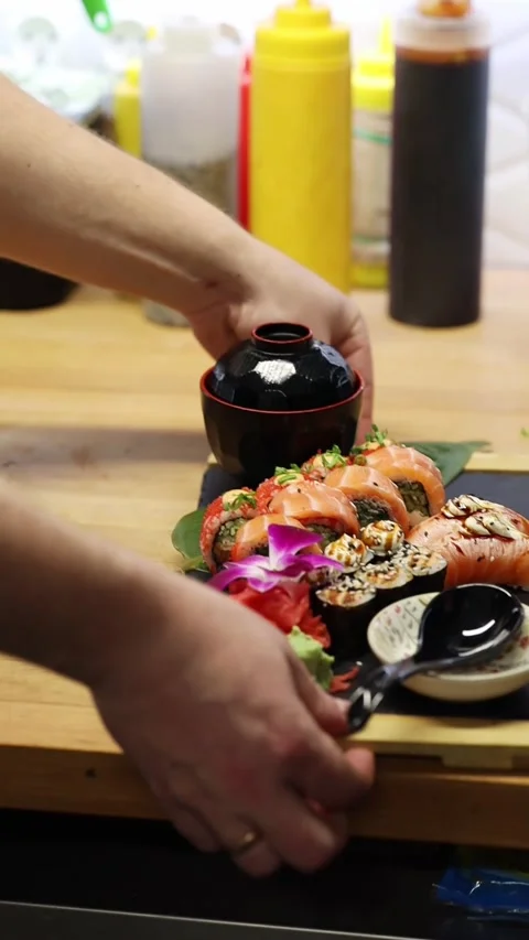 The process of making sushi rolls in a professional restaurant kitchen Видео 332490398