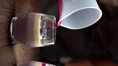 The process of making sweet and cold panna cotta dessert using blueberries and Stock Footage 250517897