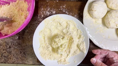 The process of making syrniki, the curd dough is rolled in flour and a round bla 動画素材 301327173