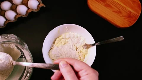 Process of making syrniki. Step 4 - make dough, add flour to curd mixture. Top Stock Footage 311190266