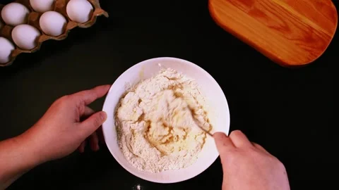 Process of making syrniki. Step 5 - mix curd mass and flour until thick Stock Footage 311447462