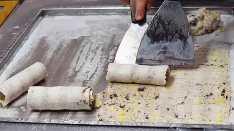 Process of making Thai ice cream rolls, or Stir-fried ice cream Stock Footage 324874101
