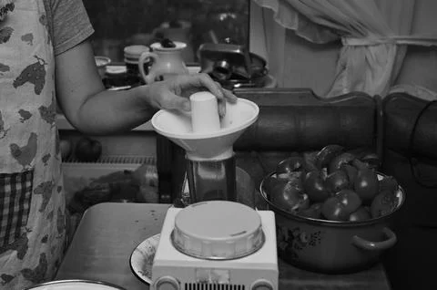 The process of making tomato juice, with human hands, objects, and tomatoes.. Stock Photos