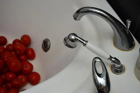 The process of making tomato juice, with human hands, objects, and tomatoes.. Stock Photos
