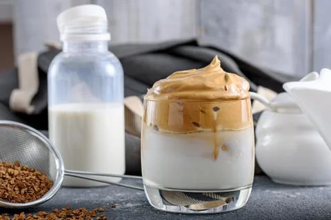 Process making trendy dalgona coffee on gray kitchen table, Korean drinks con Stock Photos