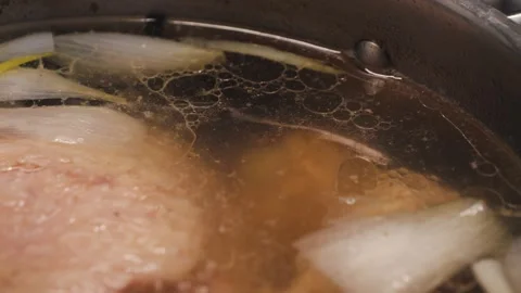 Process of making turkey soup. Boiling broth with turkey legs and vegetables Video stock 314904862
