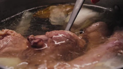 Process of making turkey soup. Boiling broth with turkey legs and vegetables Video stock 322597298