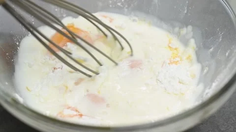 Process of making vanilla pudding. Mixing ingredients in glass bowl. Stock Footage 151693377