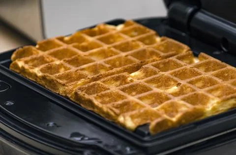 The process of making waffles. Belgian waffles cooking process Stock Photos