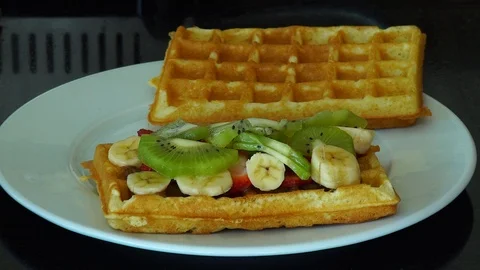 The process of making waffles. Great dessert with fruit. Stock Footage 111908325