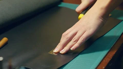 The process of making a wallet from leather. Marking and cutting, black wallet Stock Footage 169594746