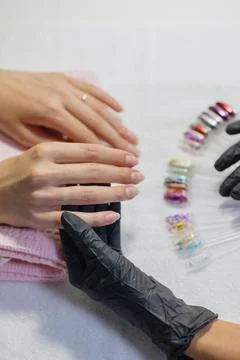 The process of manicure in a studio or beauty salon for women. a manicure and Stock Photos